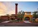 Exterior view of Info Center & Coffee Co. features unique architecture, desert landscaping and pedestrian-friendly pathways under a sunset sky at 20301 W Turney Ave, Buckeye, AZ 85396