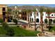 Scenic street view showcasing landscaping, palm trees, attractive architecture, and a clock tower under a clear blue sky at 20301 W Turney Ave, Buckeye, AZ 85396