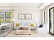 Bright living room with neutral decor, a ceiling fan, and natural light from windows and sliding glass doors at 20301 W Turney Ave, Buckeye, AZ 85396