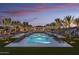 Beautiful pools with lounge chairs and umbrellas offer the perfect spot to relax and enjoy the evening sunset at 20301 W Turney Ave, Buckeye, AZ 85396
