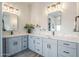 This bathroom has gray cabinets, marble countertops, and dual sinks at 2040 W Gail Rd, Queen Creek, AZ 85142