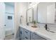 Bright bathroom features double sinks with elegant marble countertops and modern fixtures, plus a walk-in shower at 2040 W Gail Rd, Queen Creek, AZ 85142