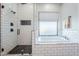 The primary bath includes a glass shower, a tub, and classic tiling at 2040 W Gail Rd, Queen Creek, AZ 85142