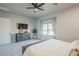 This bedroom features a ceiling fan, dresser with a television, and a large window at 2040 W Gail Rd, Queen Creek, AZ 85142