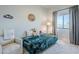 Cozy bedroom features a plush bed, calming gray walls, and a large window with natural light at 2040 W Gail Rd, Queen Creek, AZ 85142