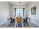 Dining room with a rustic table, accent chairs, and a window view, perfect for Gathering gatherings at 2040 W Gail Rd, Queen Creek, AZ 85142