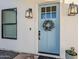 Close-up of a charming blue front door with decorative wreath and stylish sconces at 2040 W Gail Rd, Queen Creek, AZ 85142