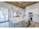 Stylish kitchen with a large island, white cabinets, and open layout to the dining area at 2040 W Gail Rd, Queen Creek, AZ 85142