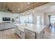 Spacious kitchen boasts an island with marble countertop and stainless steel appliances, seamlessly connected to the living room at 2040 W Gail Rd, Queen Creek, AZ 85142