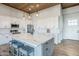 Modern kitchen featuring a large island with seating, white cabinetry, and stainless steel appliances at 2040 W Gail Rd, Queen Creek, AZ 85142
