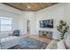 Bright living room with wood-look floors, a comfortable seating arrangement, and a stylish accent rug at 2040 W Gail Rd, Queen Creek, AZ 85142