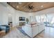 Comfortable living room features a sectional sofa, wood plank ceiling, and large windows for plenty of natural light at 2040 W Gail Rd, Queen Creek, AZ 85142