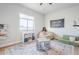 Bright playroom features a window for natural lighting, a large rug, and a play couch at 2040 W Gail Rd, Queen Creek, AZ 85142