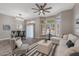 Sunlit living room with backyard views, modern furnishings, and a neutral color palette at 20407 N Tanglewood Dr, Sun City West, AZ 85375