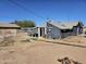 Backyard with a partially covered patio and direct access to the back of the house at 2205 W Hadley St, Phoenix, AZ 85009