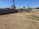 Large backyard with a metal fence and cinder block wall for privacy at 2205 W Hadley St, Phoenix, AZ 85009