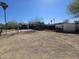View of the house exterior and gravel lot with fencing at 2205 W Hadley St, Phoenix, AZ 85009