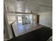 Living room view shows hardwood floors and a fan. Room is partially completed at 2205 W Hadley St, Phoenix, AZ 85009