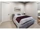 Simple bedroom with neutral carpet and walls, queen size bed, small nightstand and elephant art at 22410 N 29Th Pl, Phoenix, AZ 85050