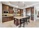 Gourmet kitchen featuring a large island with seating, stainless steel appliances, custom cabinets, and tile backsplash at 22410 N 29Th Pl, Phoenix, AZ 85050