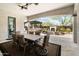 Covered patio with travertine flooring, ceiling fans, dining table, and an outdoor living area with a fireplace at 22410 N 29Th Pl, Phoenix, AZ 85050