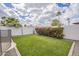 A lush backyard features artificial grass, flowering shrubs and a well-maintained white fence at 2254 S Noche De Paz --, Mesa, AZ 85202