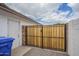 A wooden gate with a black metal frame provides access to the backyard of the property at 2254 S Noche De Paz --, Mesa, AZ 85202