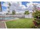An expansive backyard with artificial grass, a fenced pool, and desert landscaping at 2254 S Noche De Paz --, Mesa, AZ 85202
