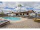 A refreshing pool is surrounded by a paved patio, palm trees, and a privacy fence at 2254 S Noche De Paz --, Mesa, AZ 85202