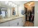 Bathroom featuring a double sink vanity, a walk-in closet, and tiled floors at 2254 S Noche De Paz --, Mesa, AZ 85202