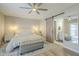 Bright bedroom featuring a ceiling fan, sliding barn door and gray bench at the foot of the bed at 2254 S Noche De Paz --, Mesa, AZ 85202