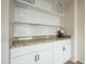 Chic coffee bar with granite countertop, white cabinetry, and space for a wine rack at 2254 S Noche De Paz --, Mesa, AZ 85202
