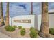 The Saratoga Center entrance is marked by lush landscaping, mature palm trees, and signage at 2254 S Noche De Paz --, Mesa, AZ 85202