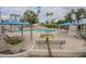 A community pool offers shaded seating, a splash pad, and desert landscaping at 2254 S Noche De Paz --, Mesa, AZ 85202