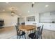 Bright dining area with wood floors, seating for six, and seamless transition to a stylish bar area at 2254 S Noche De Paz --, Mesa, AZ 85202