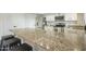 Kitchen island featuring granite counters, bar stool seating, and stainless steel appliances at 2254 S Noche De Paz --, Mesa, AZ 85202