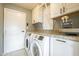 Functional laundry room with modern appliances, granite countertops, and ample storage at 2254 S Noche De Paz --, Mesa, AZ 85202