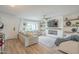 Bright living room with modern fireplace, wood-look flooring, and stylish decor at 2254 S Noche De Paz --, Mesa, AZ 85202