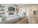 Open-concept living room featuring a modern fireplace, wood floors, and comfortable seating at 2254 S Noche De Paz --, Mesa, AZ 85202