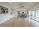 Open living room featuring vaulted ceiling, wood floors, and sightlines to kitchen and outdoor living area at 2254 S Noche De Paz --, Mesa, AZ 85202