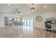 Bright, open-concept living space with modern lighting, wood flooring, and sliding door access to the pool at 2254 S Noche De Paz --, Mesa, AZ 85202