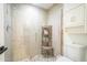 Walk-in shower with glass door, a built-in shelf and tiled walls at 2254 S Noche De Paz --, Mesa, AZ 85202