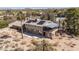 Expansive property featuring a two-story house, desert landscaping, and solar panels on the roof at 27002 N 64Th St, Scottsdale, AZ 85266
