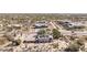 A bird's-eye view of a home surrounded by desert vegetation in a spacious neighborhood at 27002 N 64Th St, Scottsdale, AZ 85266
