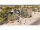 Desert landscape surrounds home with solar panels, cacti and greenery at 27002 N 64Th St, Scottsdale, AZ 85266