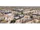 An aerial shot shows a residence with desert landscaping including cacti and green foliage at 27002 N 64Th St, Scottsdale, AZ 85266