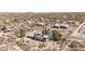An aerial photo shows a house and surrounding desert community at 27002 N 64Th St, Scottsdale, AZ 85266