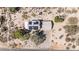 An aerial view reveals a well-maintained home with desert landscaping and solar panels at 27002 N 64Th St, Scottsdale, AZ 85266