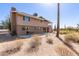 Spacious backyard featuring a two-story home with a balcony, set against desert landscape at 27002 N 64Th St, Scottsdale, AZ 85266