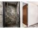 Modern tiled shower with glass door and built-in seat in the bathroom at 27002 N 64Th St, Scottsdale, AZ 85266